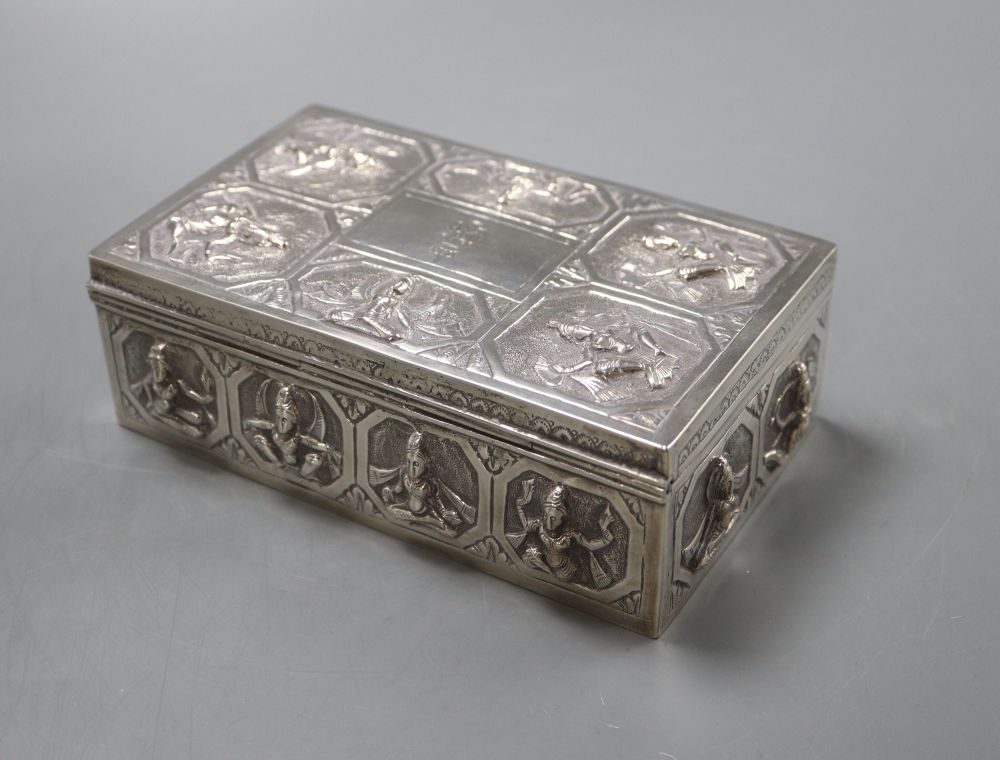 An Indian white metal cigarette box embossed with deities,15.5cm